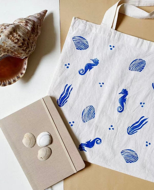 Close-up of a reusable tote bag with hand-painted and embroidered details used in everyday lifestyle setting
