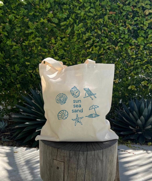 Canvas tote bag decorated with fabric patches, embroidery, and charms for daily errands