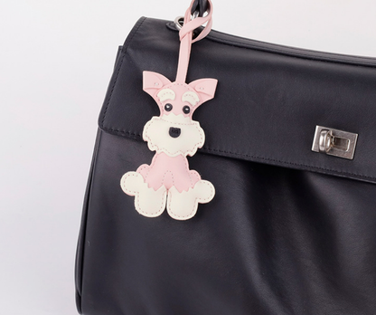 Handmade puppy keychain shown on a backpack