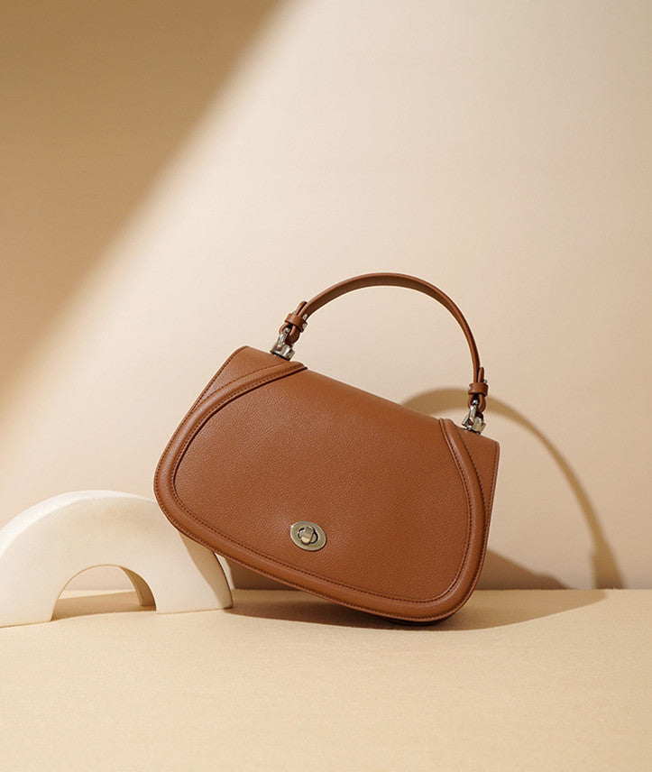 Versatile leather saddle bag women can wear crossbody or handheld