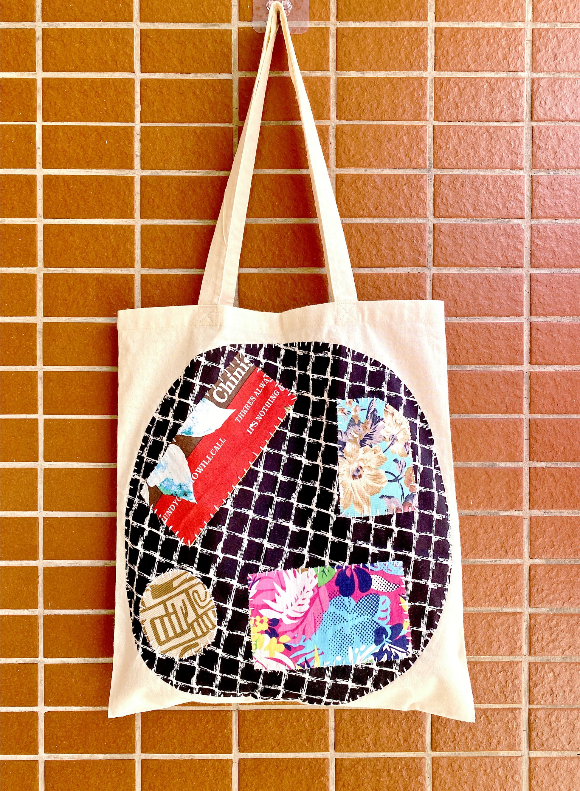 Choosing a gift that tells a story: this lightweight fabric tote features intricate patches favored by the Reddit slow-fashion community.