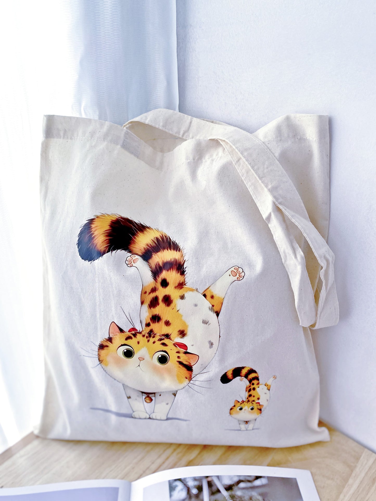 Looking for a gift that’s as practical as it is cute? This cotton tote with a hand-printed orange cat design is perfect for any occasion.