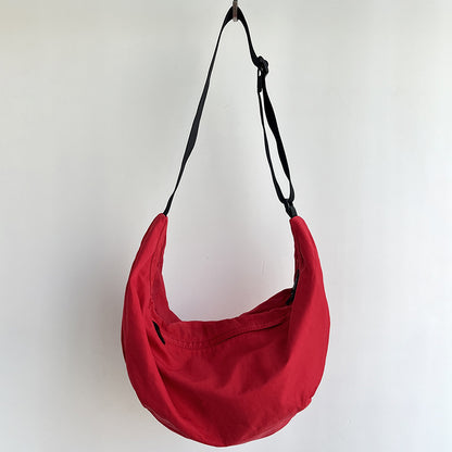 Neutral color fabric crossbody pouch with expandable main pocket