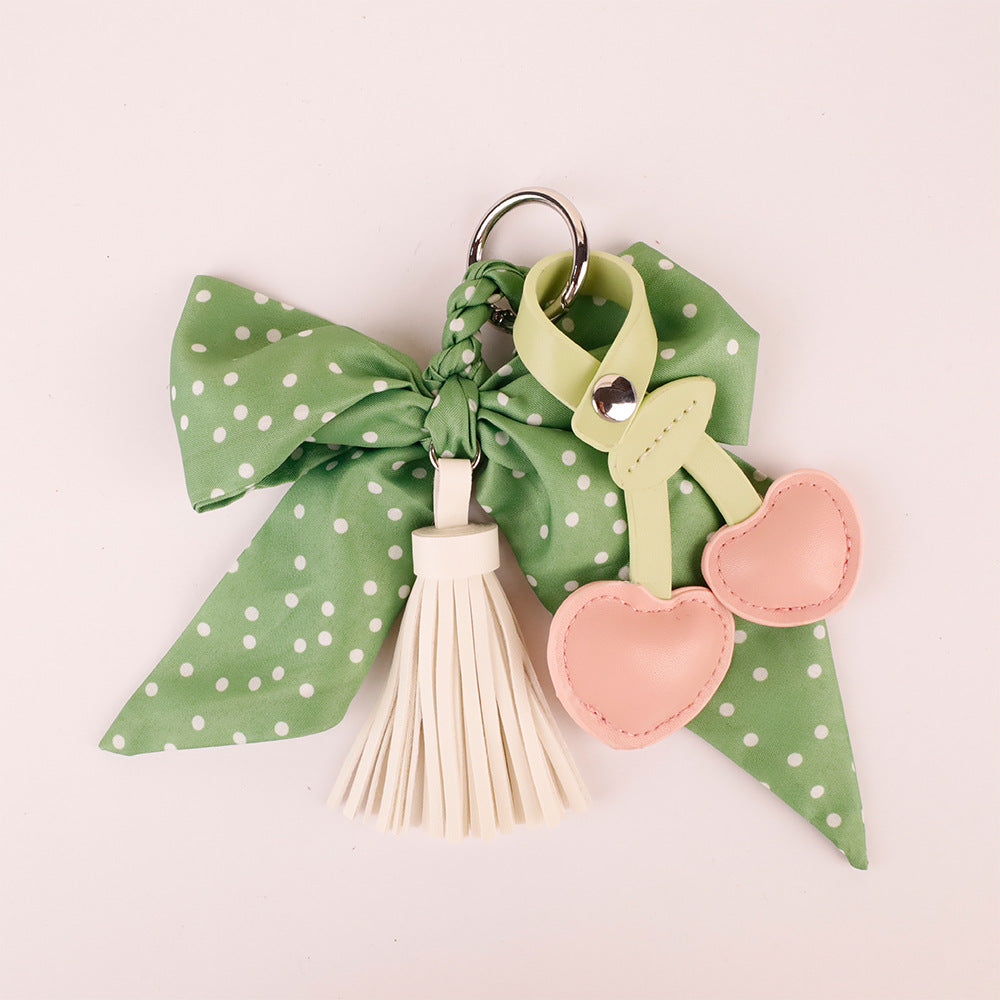 Charming green animal pendant accessory on a soft crossbody bag