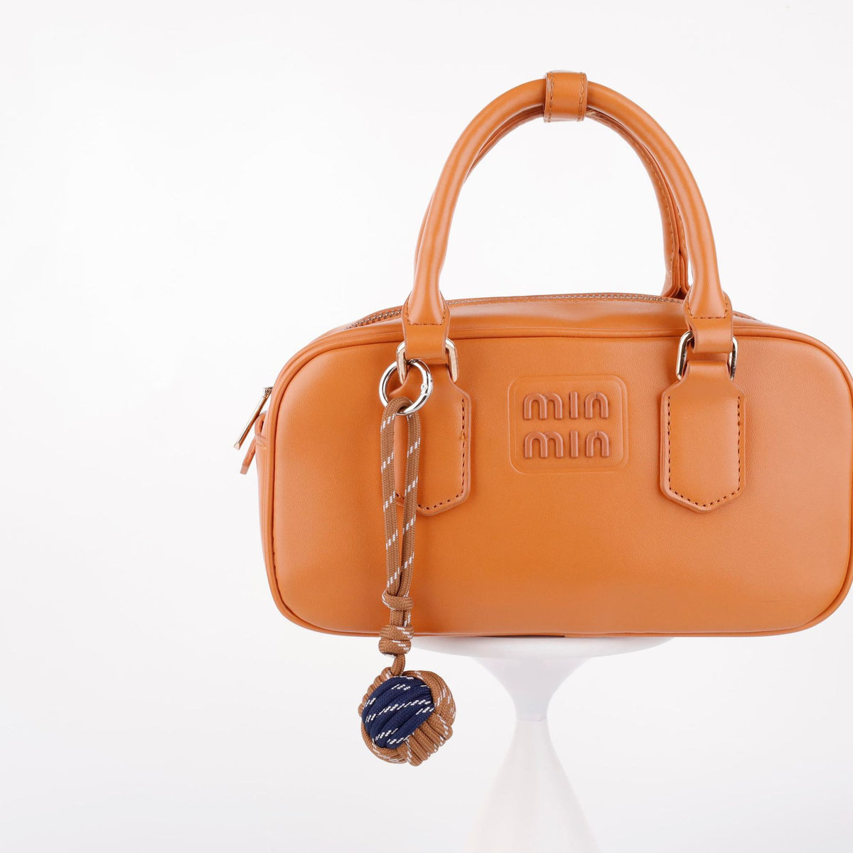 Woven rope charm for decorating a handbag or tote