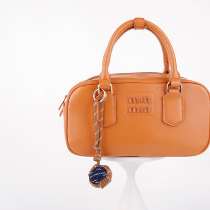 Woven rope charm for decorating a handbag or tote