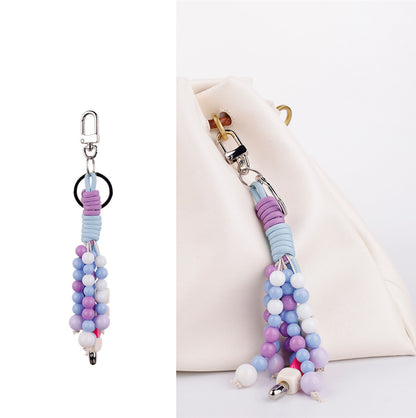 Beaded purple crystal keychain accessory wrapped around a gift box