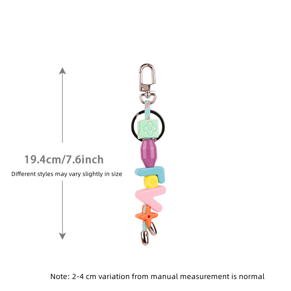 Custom letter phone charm dangling from phone case