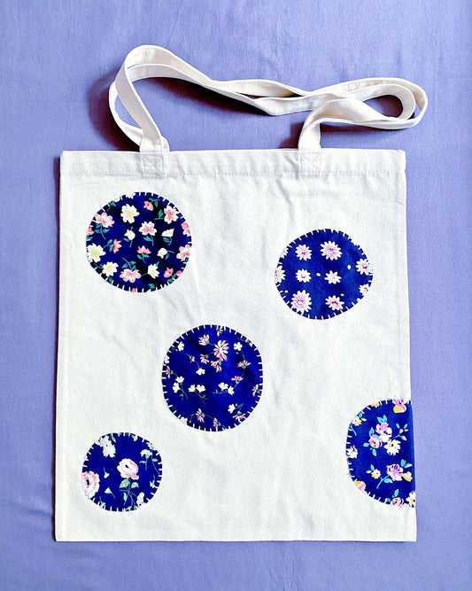 Large eco-friendly canvas tote featuring unique hand-stitched patchwork art perfect for zero-waste grocery runs.