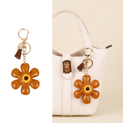 Floral bag accessory with sunflower and tassel details