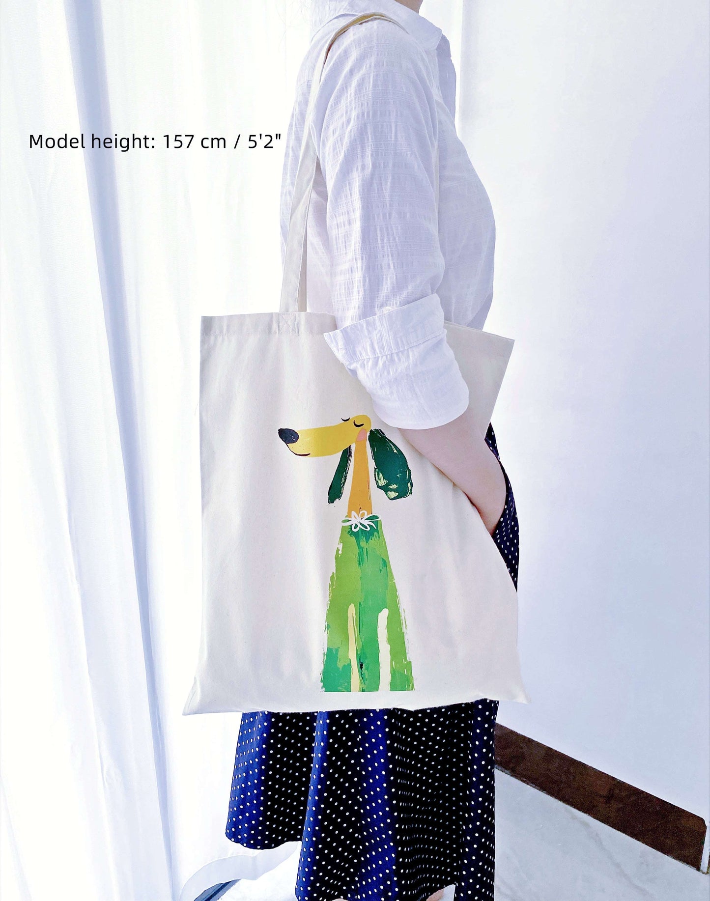 Messy creative studio vibe with a puppy print tote holding sketchbooks and charcoal pencils