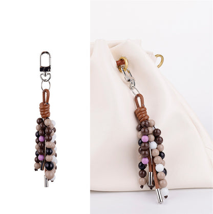 Close-up macro shot of polished gemstone beads used in a handmade artisanal bag accessory