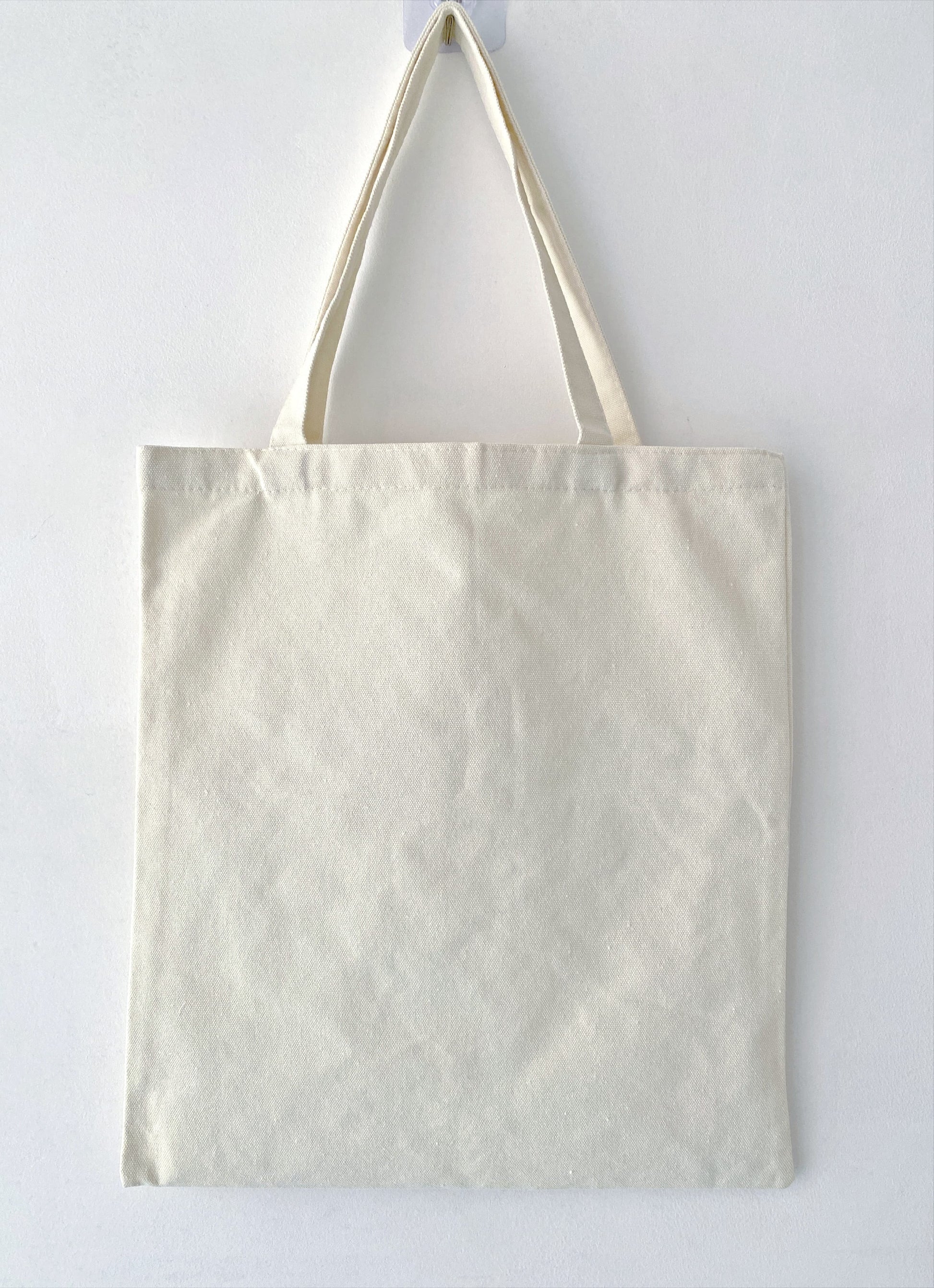 Relaxed fit canvas tote ideal for carrying books, groceries, and laptops.
