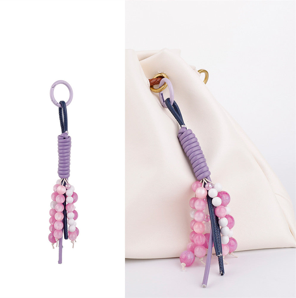 Lavender stone purse strap decoration styled on a summer shoulder bag