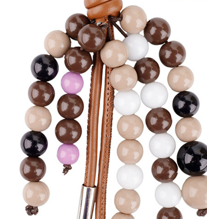 Creative handbag accessory dangling from a canvas tote bag during an outdoor autumn walk
