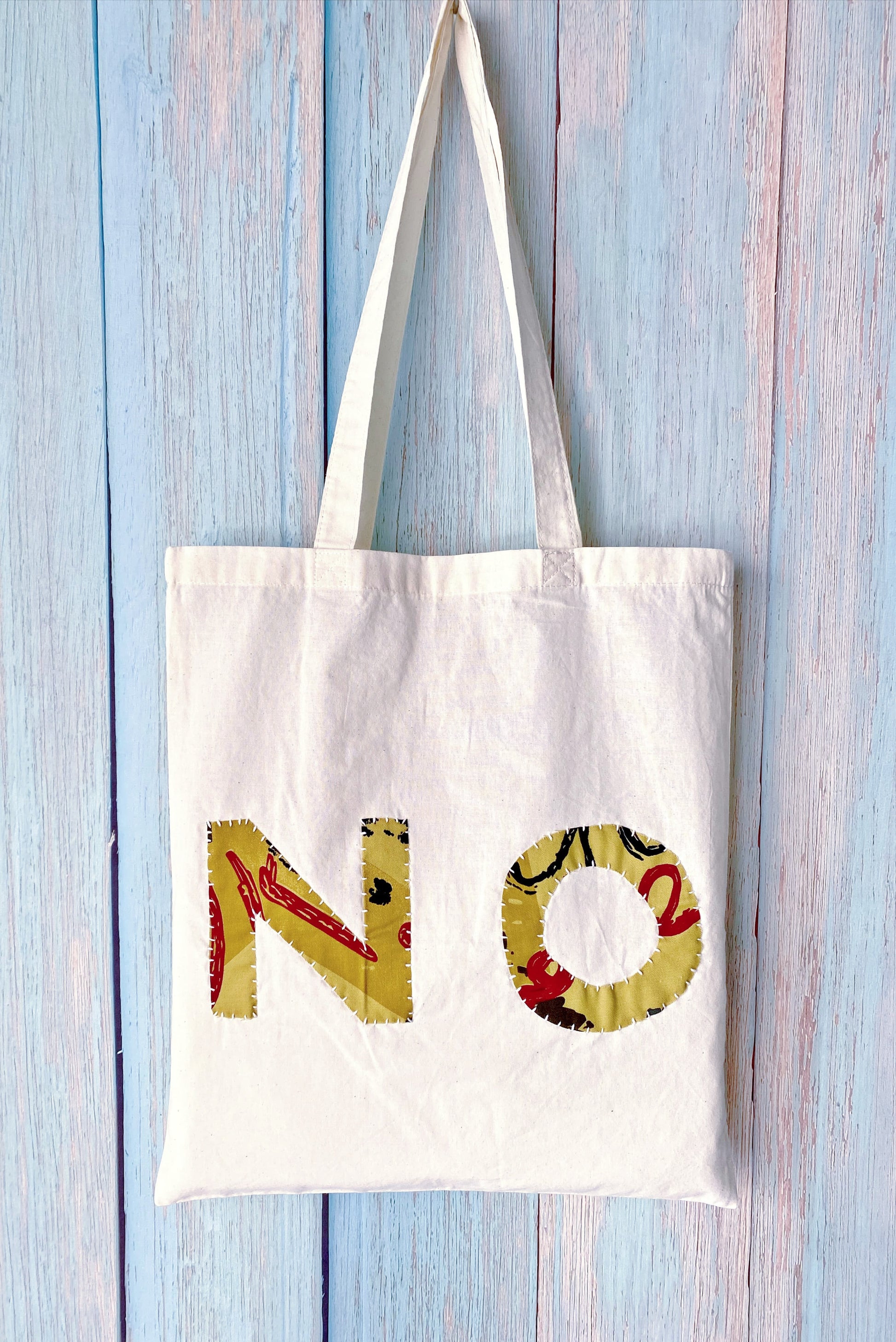 Artisan style textile tote highlighting raw edges and creative handwork meant for artistic souls and makers