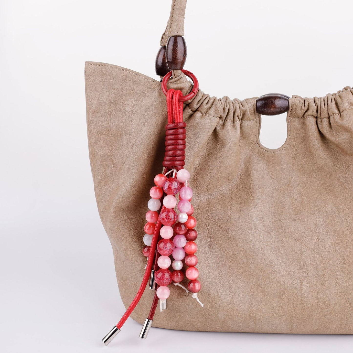 Hand-strung bead piece displayed on a shoulder bag