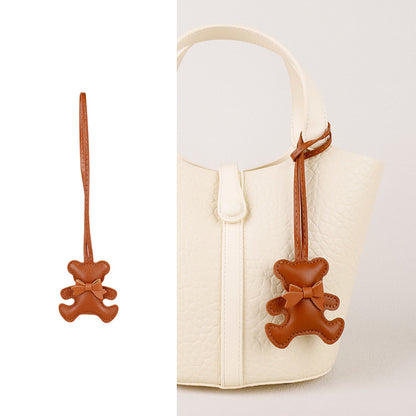 Cute brown bear purse charm paired with a silky graphic neck scarf ribbon