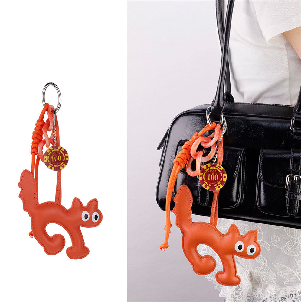 Charming cat keychain sitting beside a handwritten birthday card