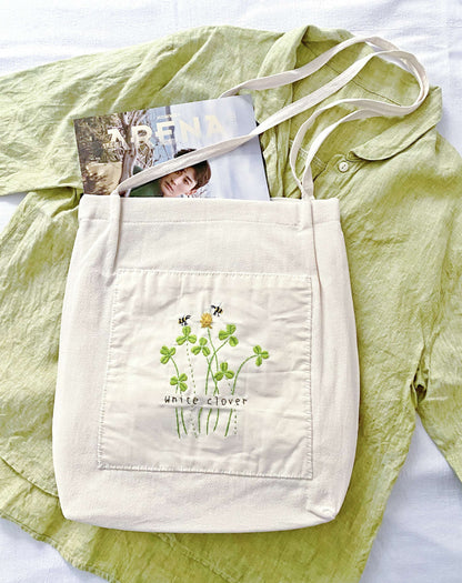 A soft linen shoulder bag where hand-embroidery adds a personal, heirloom-quality feel.