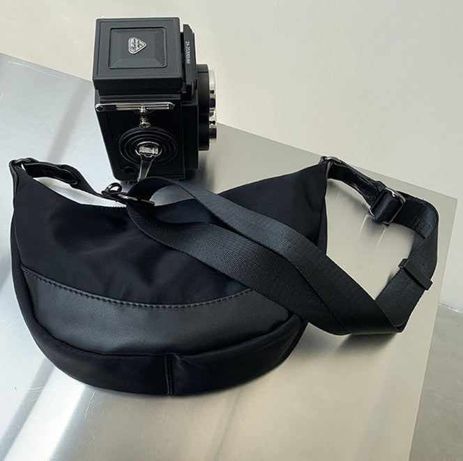 compact crossbody bag sized to hold daily essentials only