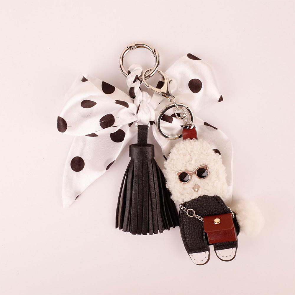 Animal charm with a classic black white bow