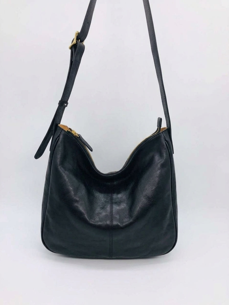 Leather crossbody purse worn for sightseeing during a short holiday