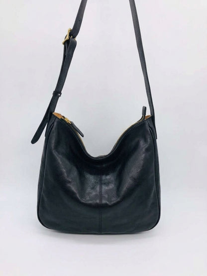 Leather crossbody purse worn for sightseeing during a short holiday