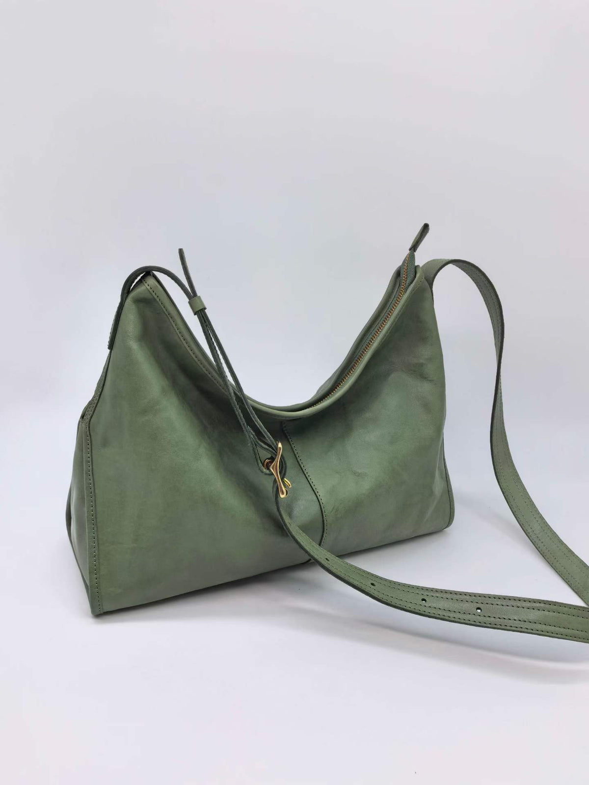 Adjustable strap leather bag worn crossbody for hands-free errands