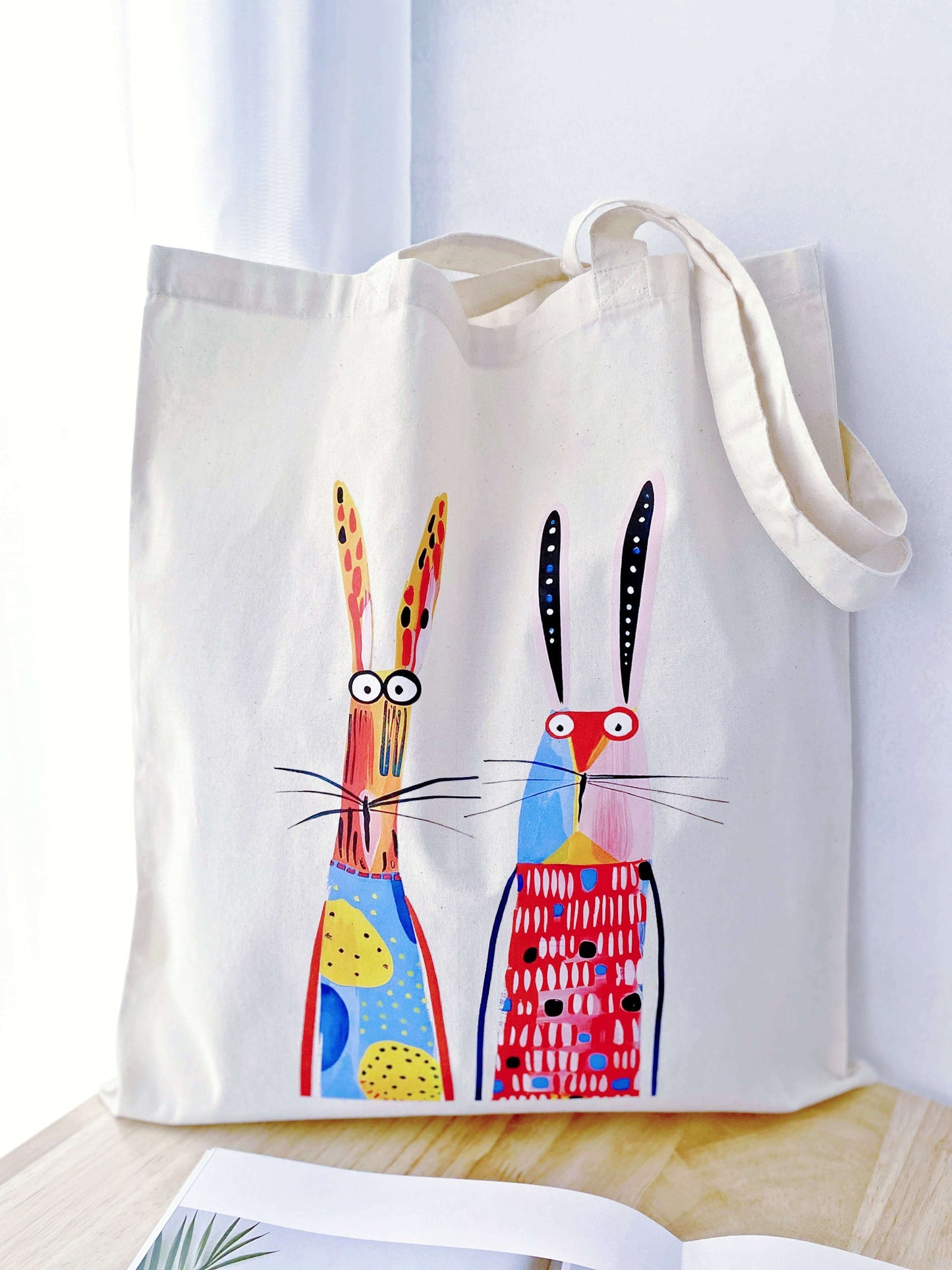 Detail of the imperfections in the hand-printed rabbit art on a cotton bag, showing the human touch that distinguishes it from mass-produced factory items.
