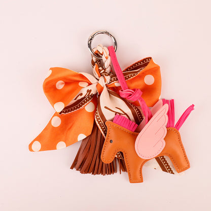 Orange bow tassel accessory for personalizing a handbag