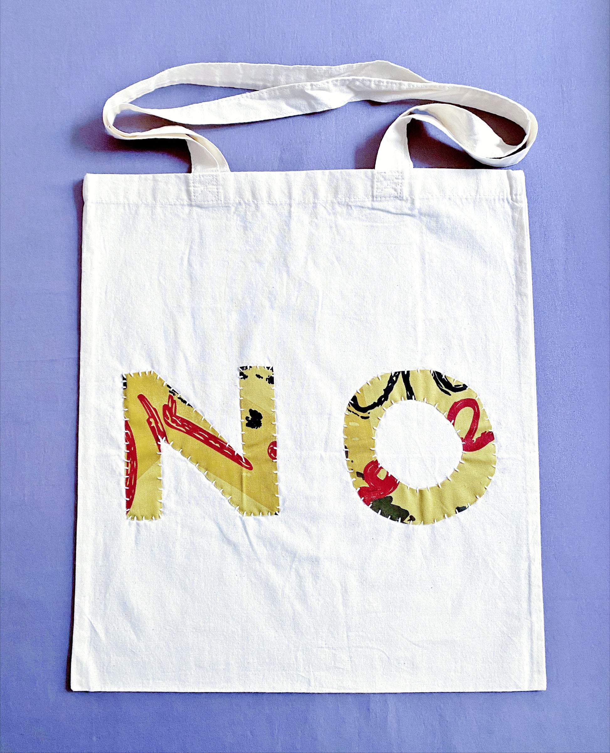 Soft natural cotton tote featuring unique hand stitched patchwork art for zero waste grocery shopping trips