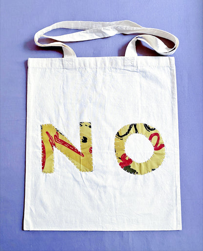 Soft natural cotton tote featuring unique hand stitched patchwork art for zero waste grocery shopping trips