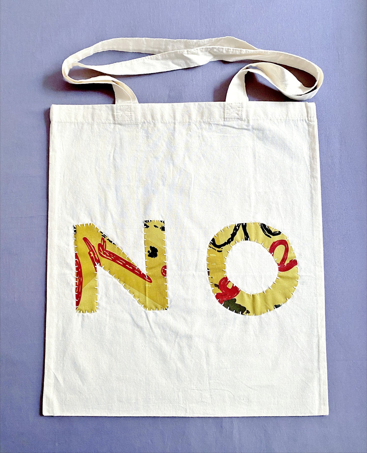 Natural cotton tote bag with hand-stitched DIY patchwork design.