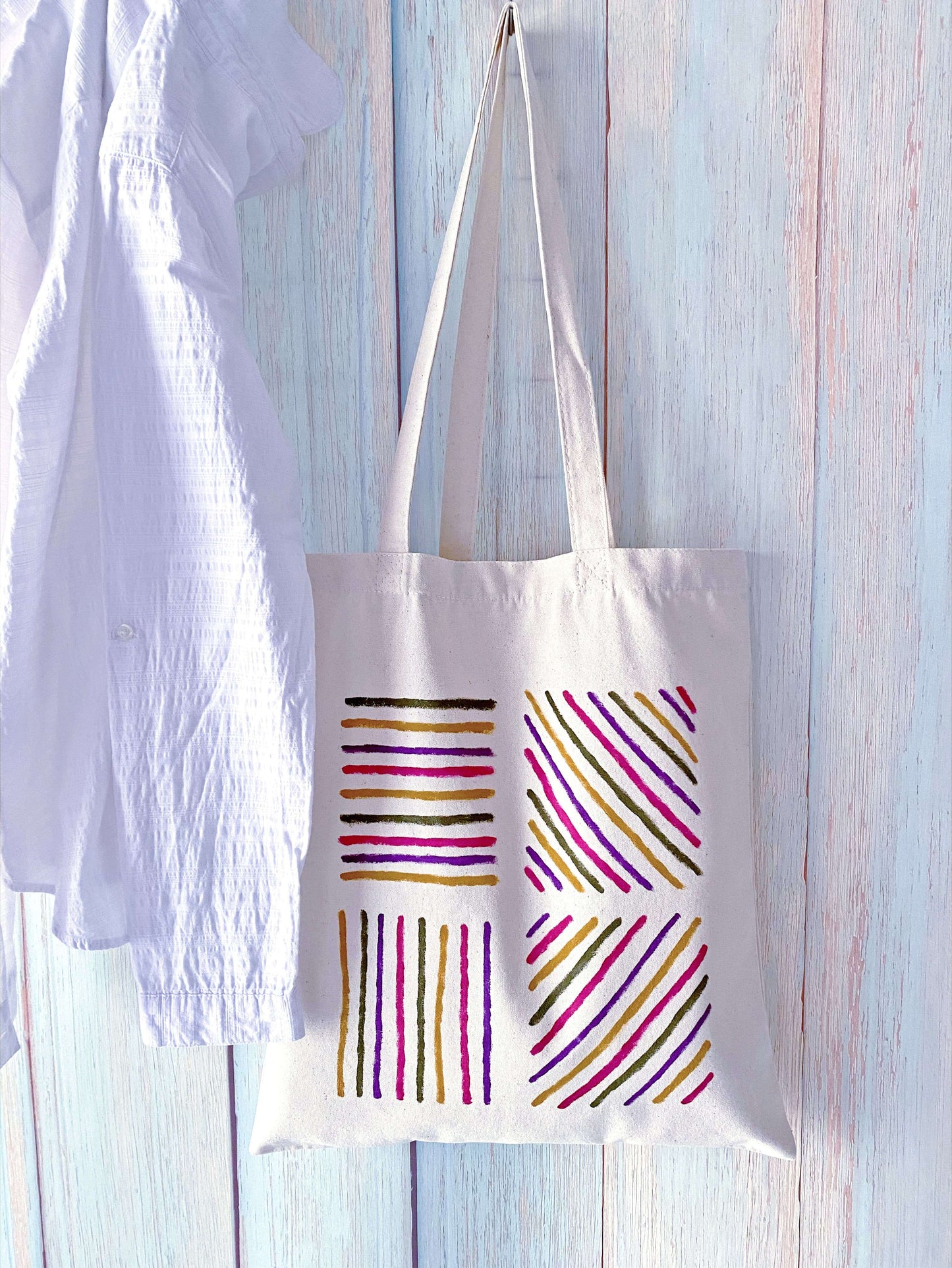 Large interior view of a cotton tote holding a picnic blanket and fruit.