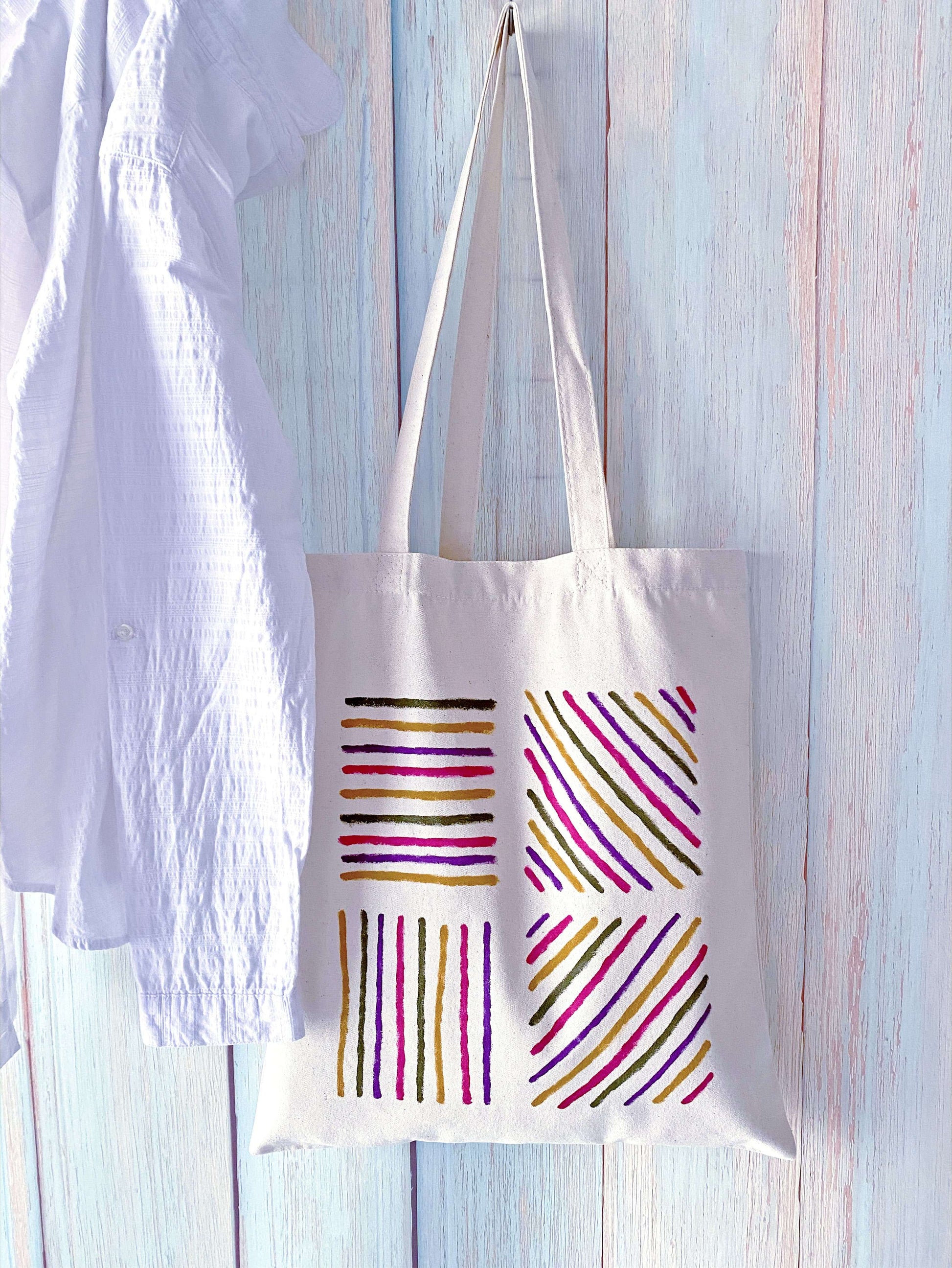 Large interior view of a cotton tote holding a picnic blanket and fruit.