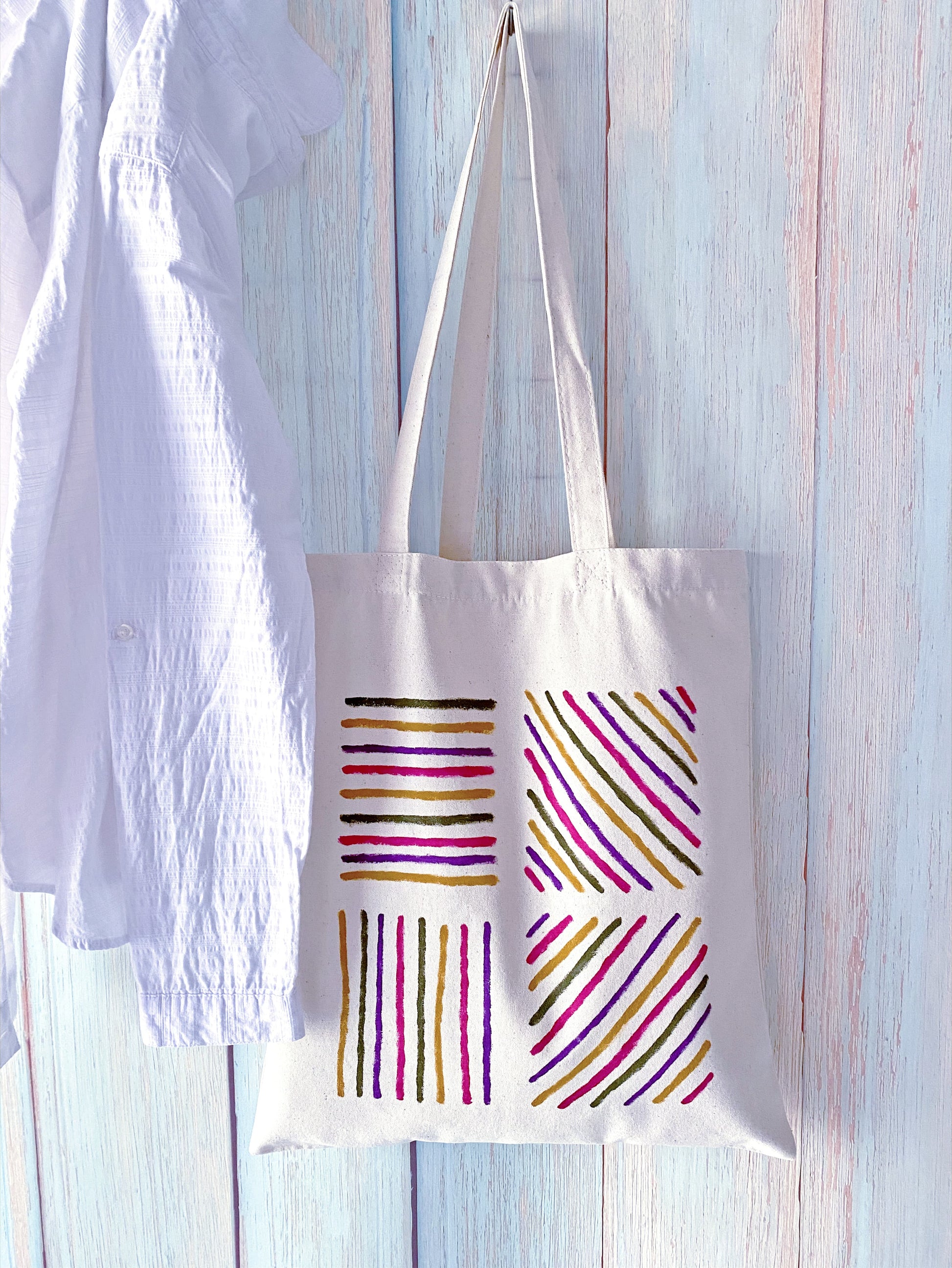 Large interior view of a cotton tote holding a picnic blanket and fruit.