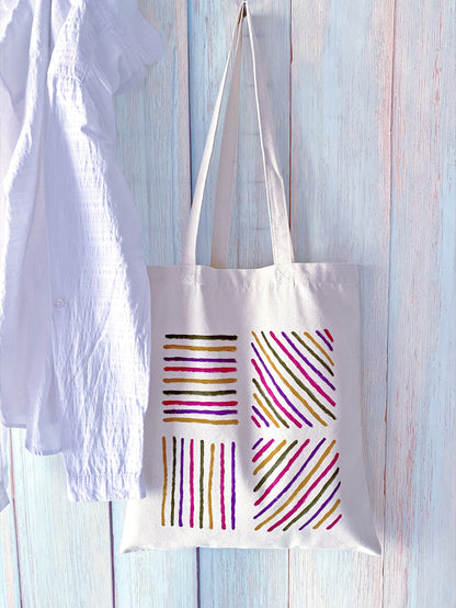 Large interior view of a cotton tote holding a picnic blanket and fruit.