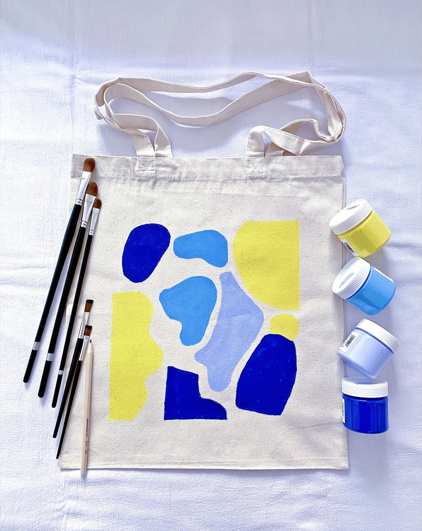 roomy everyday tote made from cotton canvas with a small artistic drawing