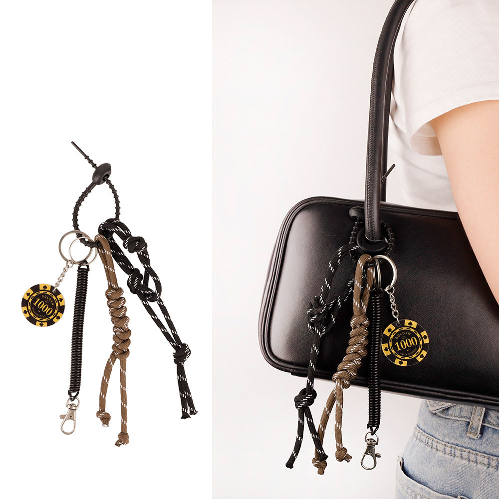 Tassel keychain accessory clipped to a tote bag