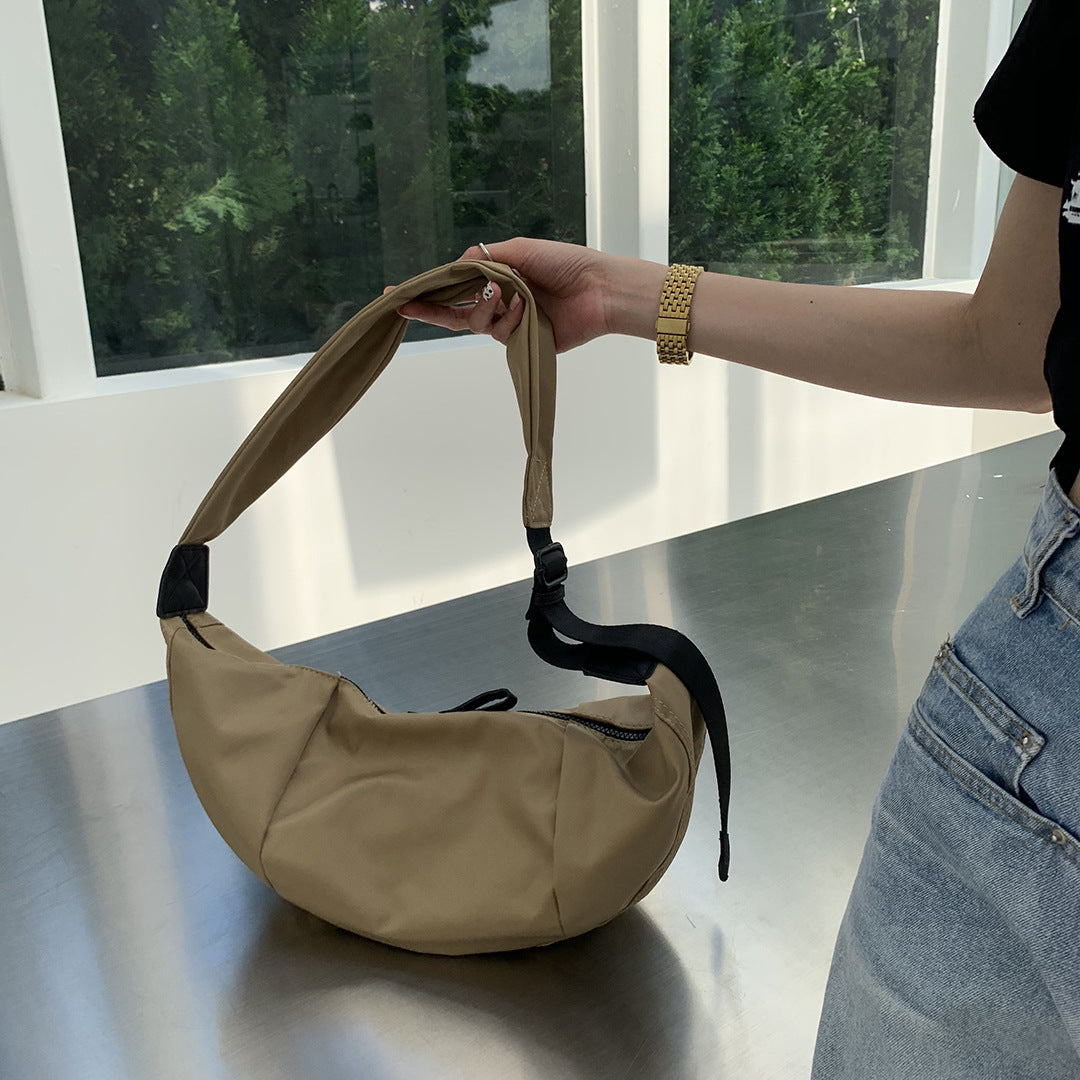 Women's curved sling purse for comfortable everyday travel