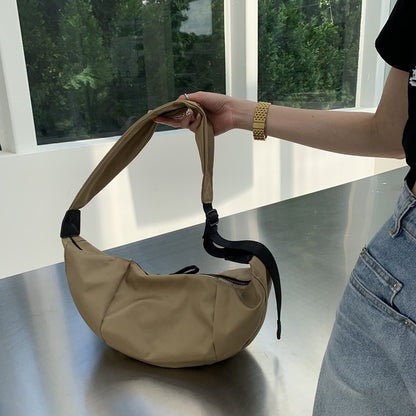 Women's curved sling purse for comfortable everyday travel