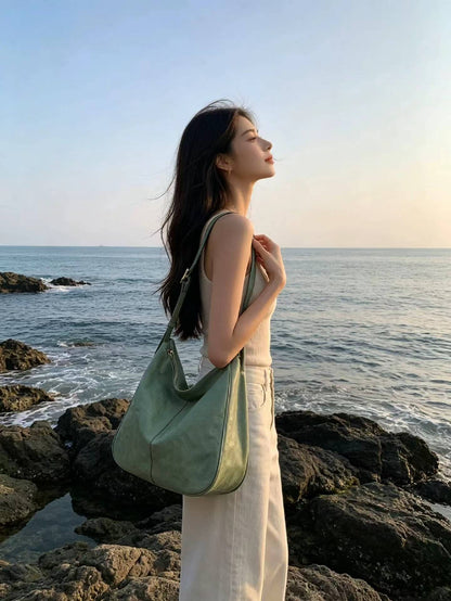 Leather shoulder handbag worn with jeans for a casual lunch with friends