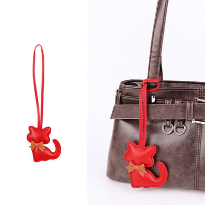 Cute cat hanging accessory for a shoulder bag