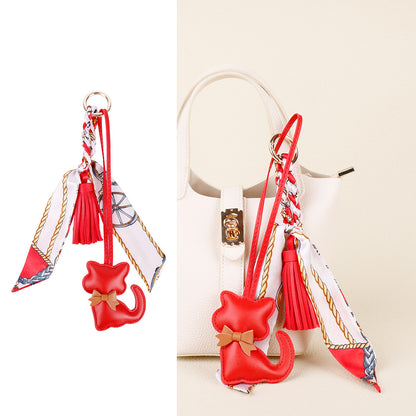 Cat keychain accessory with a playful tassel