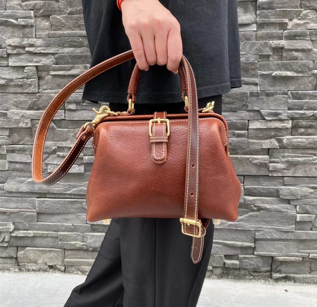 2024 Vintage handbag, doctors bag style. Brown leather, two pockets, handle & strap, strong metal push clasp.