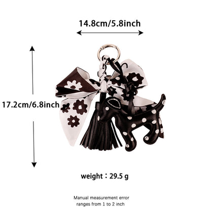 Black and white fabric bow keychain displayed with house keys