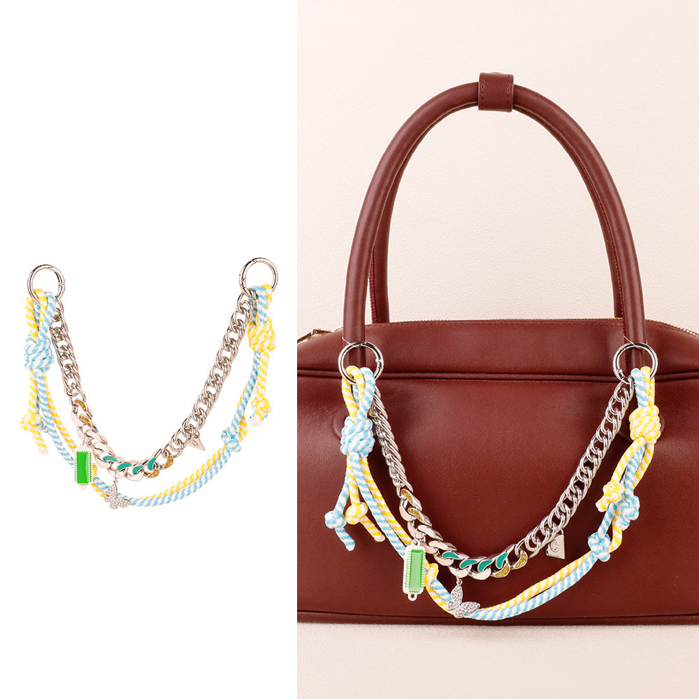Dual layer woven keychain accessory clipped onto a women designer clutch