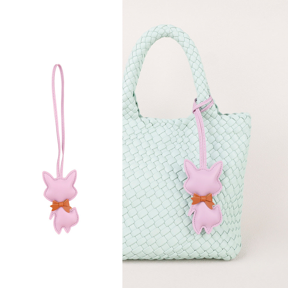 Decorative fox charm clipped to a backpack for everyday use