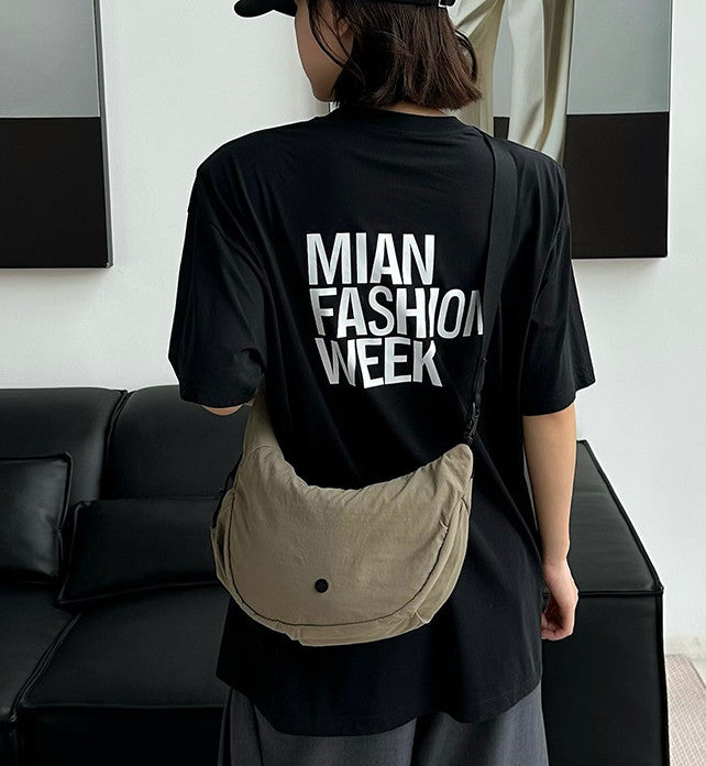 Soft women's sling bag worn across the body for city walks